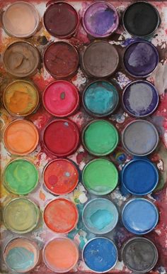 an open box with many different colors of paint