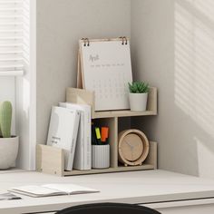 a desk with a clock, plant and other office supplies