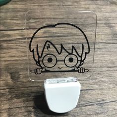 a close up of an electronic device on a table with a cartoon character drawn on it