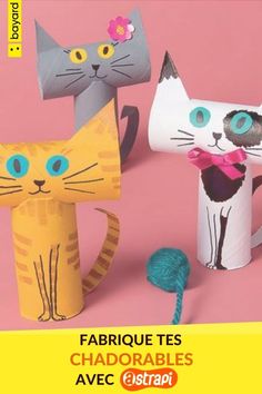 three paper cats are standing next to each other