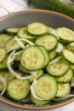 sliced cucumbers in a bowl with a spoon