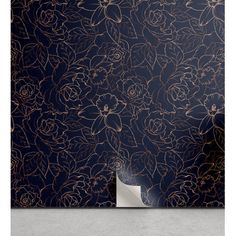 a wallpaper with gold foil flowers and leaves on black paper, in front of a dark blue background