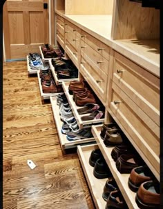 the shoes are lined up on the drawers in the closet