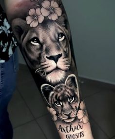 a woman with a lion and tiger tattoo on her arm