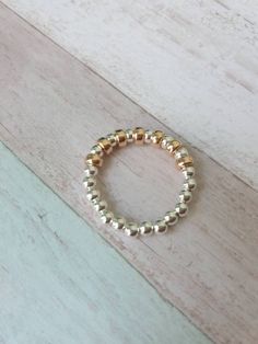 Fabulous handmade Rose Gold & Sterling Silver Stretch Ring. It looks great alone or with other stacker rings ⭐ 3mm Sterling Silver Beads. ⭐ 4mm Rose Gold Filled Flat Rondelle Beads.  The ring measures 6.5cm which will fit most fingers. However if you would like a smaller or larger ring please message before purchasing as prices may vary dependant on size.  Measuring your ring finger: wrap a length of cotton around the finger where you would like the ring to sit, then measure the cotton from end Silver Heart Bracelet, Stacker Rings, Sterling Silver Bead Bracelet, Handmade Rose, Beaded Ring, Stretch Ring, Silver Bead Bracelet, Ring Rose Gold, Large Ring