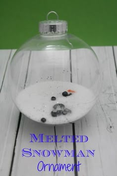 melted snowman ornament with blueberries in it