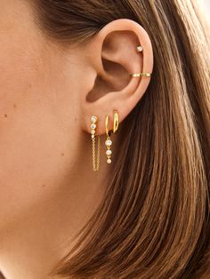 Introducing our Jenelle 18k Gold Earring Set – three times the charm in one stylish set. Choose between dainty drop earrings, delicate huggies with a shimmering drop accent, and a timeless huggie. Wear them all together or mix and match depending on your everyday mood. Either way, you’re set for years of style, thanks to its 18K gold plated sterling silver and Cubic Zirconia stones. Stack Hoop Earrings, Stack Earring Ideas, Cute Stacked Earrings, Gold Hoops Triple Piercing, Multi Piercing Earrings, Earring Inspiration Gold, Hairstyles For Big Earrings, 3 Earring Set, Opal And Gold Earrings