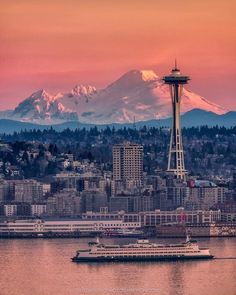 the space needle in seattle, with mount rainier in the background