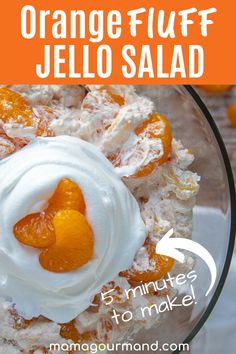 orange fluff jello salad in a glass bowl with whipped cream and fruit on top