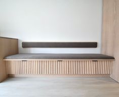 a wooden bench sitting in the middle of a room