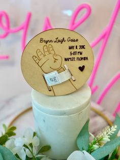 a wooden sign on top of a jar with flowers around it and the words born to be gay