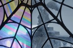 two stained glass windows with an image of a person holding an umbrella in the rain