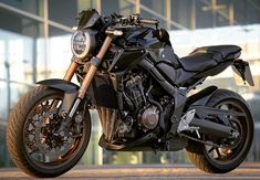 a black motorcycle parked in front of a building