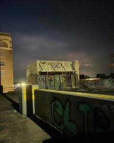 a building with graffiti on it next to a parking lot