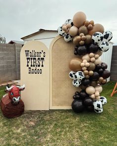 an inflatable balloon sculpture with cow heads and balloons attached to the side of it