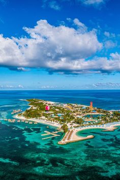 an island in the middle of the ocean surrounded by blue water and white sandy beaches