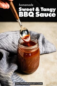 homemade sweet and tangy bbq sauce in a mason jar with a wooden spoon