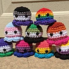 a group of small crocheted hats sitting on top of each other in front of a door