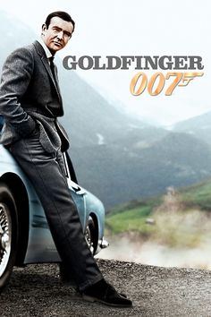 a man in a suit sitting on top of a blue car with the words goldfingerer