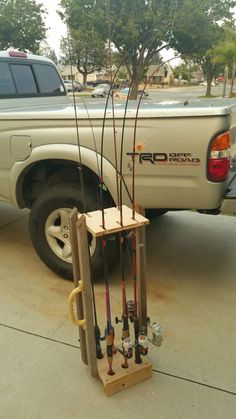 a truck is parked next to a rack with fishing rods