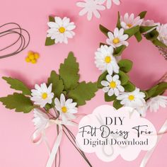 some daisies and other flowers are on a pink surface with the words diy felt daisy hair kit