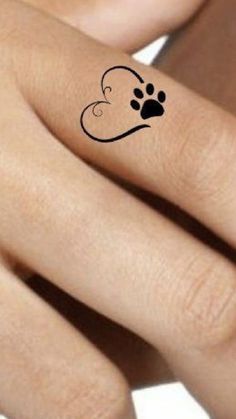 a woman's hand with a dog paw tattoo on it