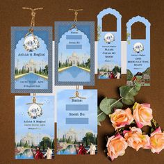 the wedding stationery is laid out on top of a table with flowers and cards