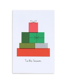 a card with presents stacked on top of each other and the words tis the season