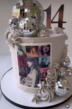 a birthday cake decorated with disco balls and pictures on the top is an image of a woman's face