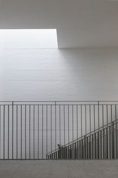 an empty room with stairs leading up to the ceiling