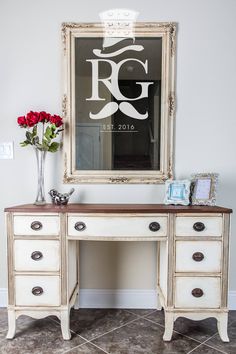 a white desk with drawers and a mirror above it