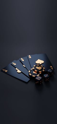 the back side of a set of black and gold playing cards with dice on it