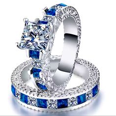 two wedding rings with blue and white diamonds