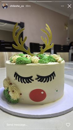 a decorated cake with green frosting and gold antlers on it's face