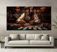 a man sitting at a table with cards in front of him on a wall above a couch