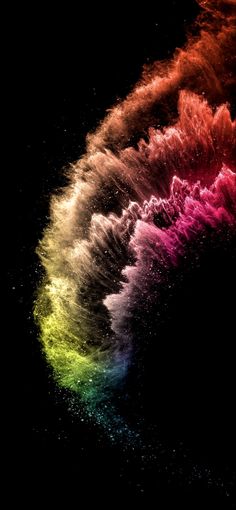 an image of colorful fireworks in the dark sky with water splashing on it's side