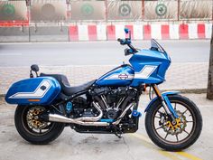 a blue motorcycle is parked on the street