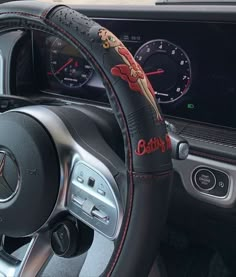 the steering wheel cover is decorated with an image of a dragon on it's side