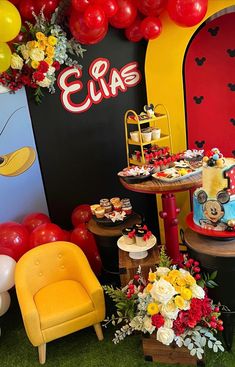 a mickey mouse themed birthday party with balloons and desserts on the table, along with winnie the pooh cake