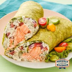 two wraps filled with salmon and vegetables on a plate