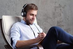 a man sitting in a chair with headphones on