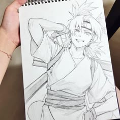 a drawing of naruto is being held by someone's hand