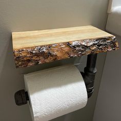 a toilet paper holder made out of wood