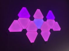 a purple and blue light with hexagonal shapes in the middle on a black background