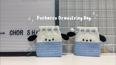 two small knitted sheeps sitting next to each other