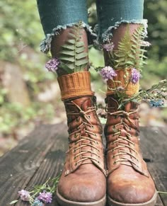 a pair of boots with plants growing out of them