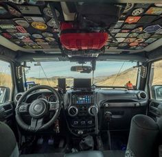 the interior of a vehicle with many stickers on the ceiling and dash board,