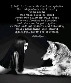 a woman sitting next to a wolf with a quote on it that says, i fell in love with the free spirits