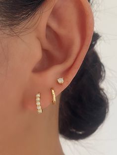 This must-have 3-pair opal earrings set is a treasure trove of sophistication. Crafted from high-quality 925 sterling silver and elegantly 18k gold plated, features stunning opal gemstones that add a touch of celestial charm to your everyday look. Whether you choose to wear a single set for understated elegance or stack all three pairs for a trendy ear stack, these earrings are essential for achieving an elegant and radiant style.Available in Gold and Silver Finish• Sold as a Pair (3 pairs come Ears With 3 Piercings, 3 Rd Piercing, Three Ears Pierced, Earrings For Three Piercings, 2 Peircings Earring Gold, 3 Piercing Ideas, Cute Dainty Piercings, Triples Earring Combos, 3 Percinings Ear