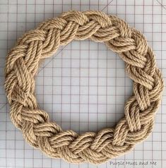 a rope wreath on top of a cutting board